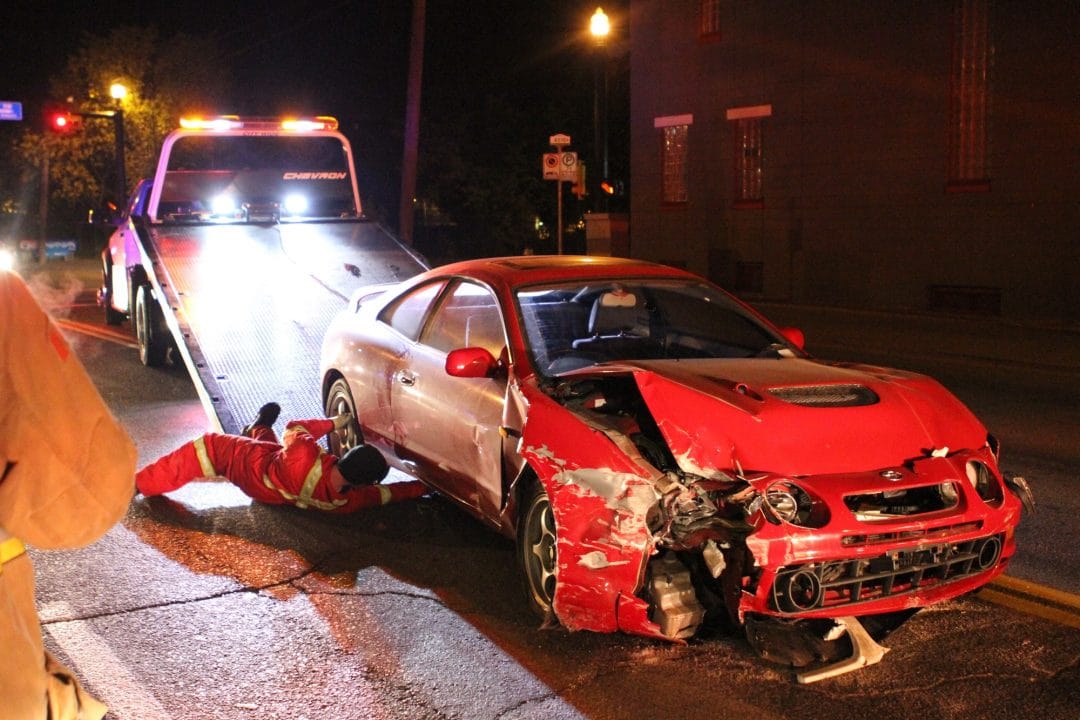 a-wrecked-car-is-loaded-onto-a-tow-truck-after-crashing-through-a-brick-wall-on-17th-ave-sw.jpg